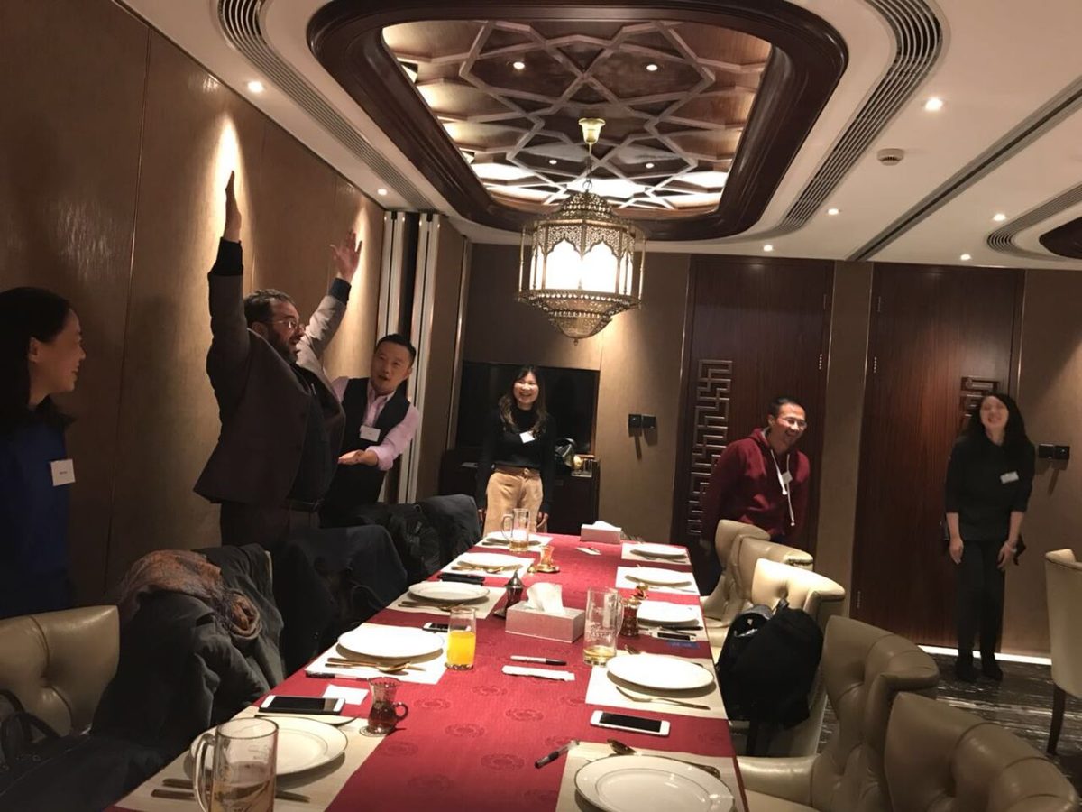Participants raising their hands during a group icebreaker activity