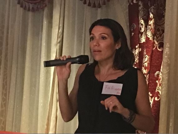 A participant speaking into a microphone at an earlier presentation-skills event